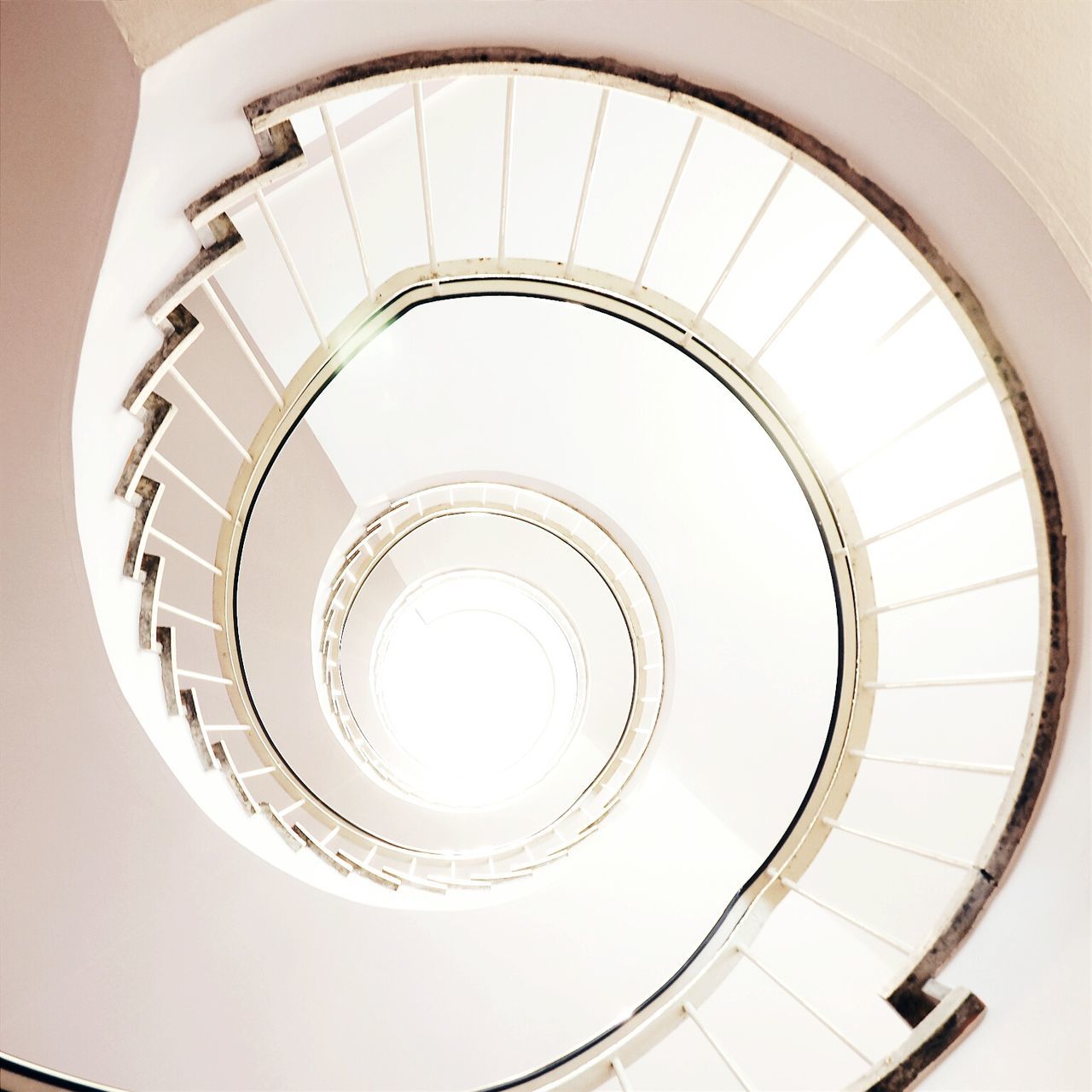 steps and staircases, staircase, spiral, indoors, architecture, spiral staircase, built structure, steps, railing, low angle view, modern, directly below, pattern, circle, building, building exterior, stairs, geometric shape, design, high angle view