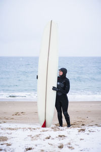 Young woman going winter surfing in snow