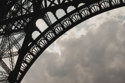 Low angle view of silhouette bridge against sky