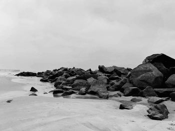 Rocks on beach against sky