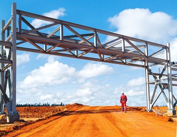 Worker walking down a bridge