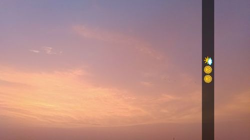 Low angle view of illuminated pole against sky at night