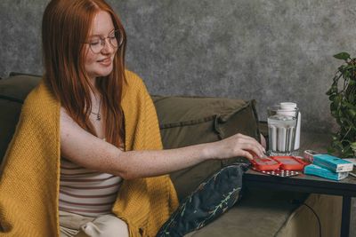 Young woman sorting her medications at home, highlighting personal responsibility in health care