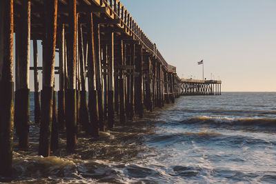 Pier over sea against clear sky