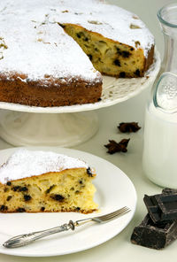 Close-up of cake with milk and chocolate bars on table