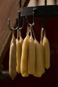 Close-up of candles hanging from hooks in workshop