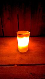 Close-up of illuminated lamp on table
