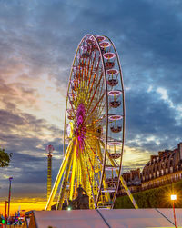 Low angle view of ferris wheel against sky