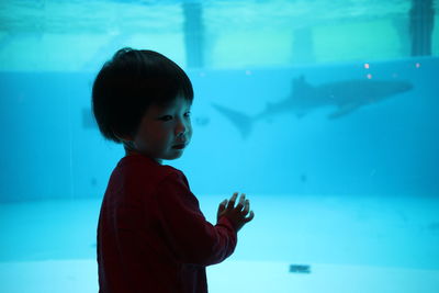 Boy swimming in aquarium