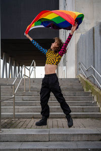 Rear view of man holding umbrella