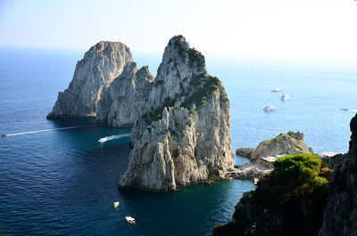 Scenic view of rocks in sea against sky