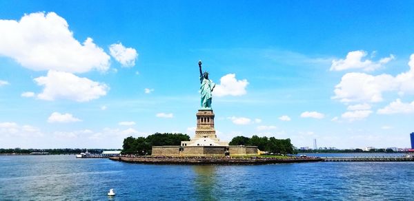 Statue of liberty against cloudy sky