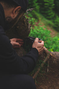 Man looking at camera in forest