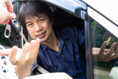 Portrait of woman smiling in car