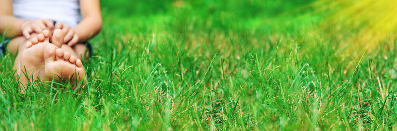 Low section of woman standing on field