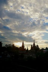 Buildings in city against sky during sunset