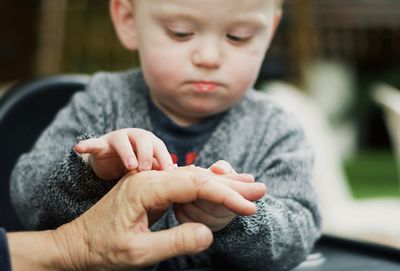 Close-up of boy sitting at home