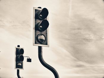 Low angle view of traffic light against sky