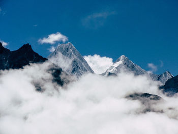 Low angle view of snowcapped mountains against sky