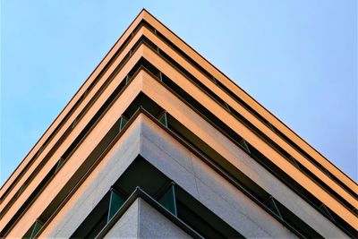 Low angle view of the corner of a building against clear sky