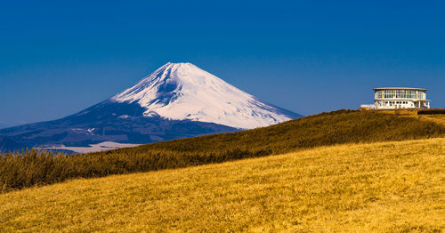 Summit of mountain ridge pass with fields of grass and view of mt. fuji.