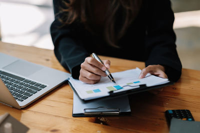 Midsection of businesswoman working at office