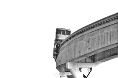 Low angle view of bridge and building against clear sky