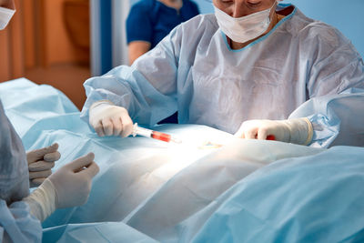 Midsection of doctor examining patient at clinic