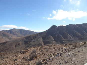 Scenic view of mountains against cloudy sky