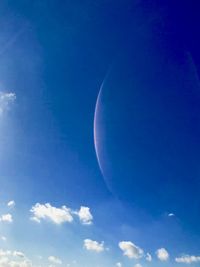 Low angle view of moon against blue sky