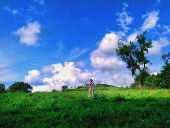 Man standing on field against sky