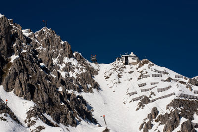 Scenic view of snow covered mountain against clear blue sky