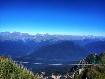 Scenic view of mountains against clear blue sky