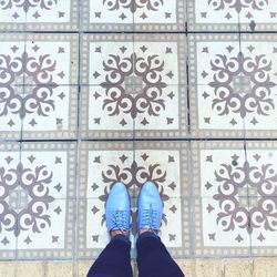 Low section of people standing on tiled floor