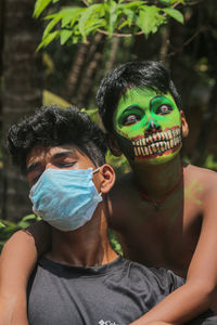 Portrait of father and boy wearing mask