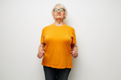 Portrait of woman standing against white background
