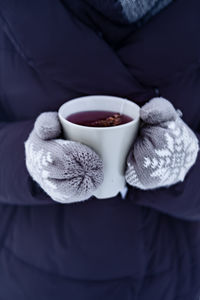 Close-up of hand holding coffee cup