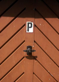 Letter p on brown door