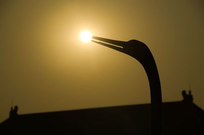 Silhouette of woman at sunset