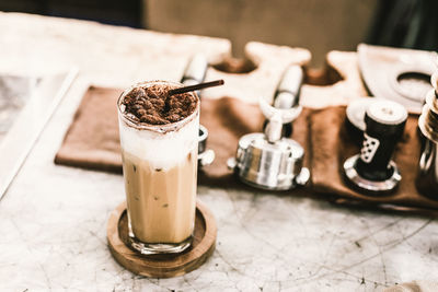 Cold coffee in glass on table