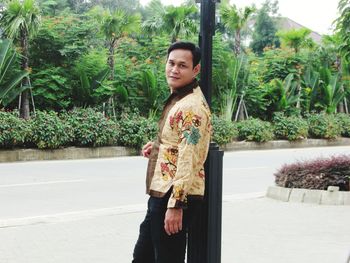 Portrait of man standing against plants