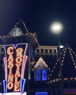 Low angle view of illuminated building against sky at night