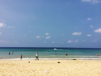 Scenic view of beach against blue sky