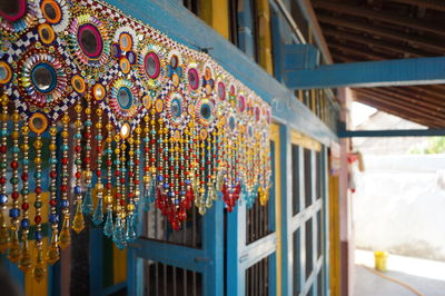 Close-up of multi colored decorations hanging in building