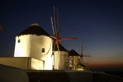 Low angle view of traditional windmill against sky