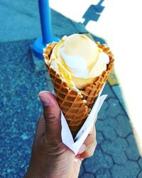 Cropped hand holding ice cream