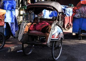 People sitting on road in city