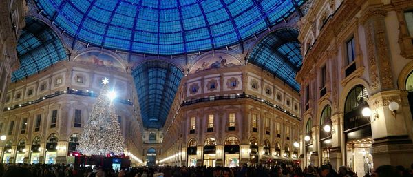 Panoramic view of people in city at night