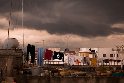 Clothes drying on building terrace during sunset