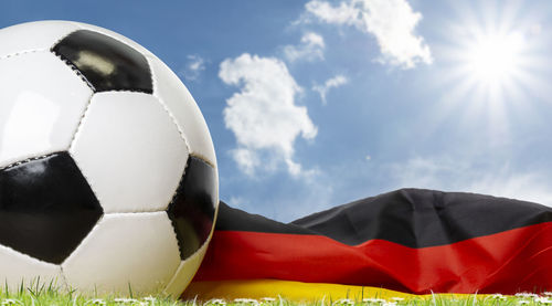 Low angle view of soccer ball on field against sky